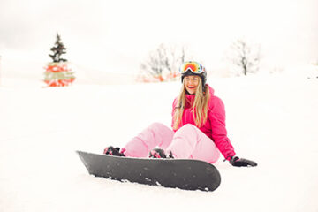 Woman in snowboard suit. Sportswoman on a mountain with a snowboard in the hands on the horizon. Concept on Sports